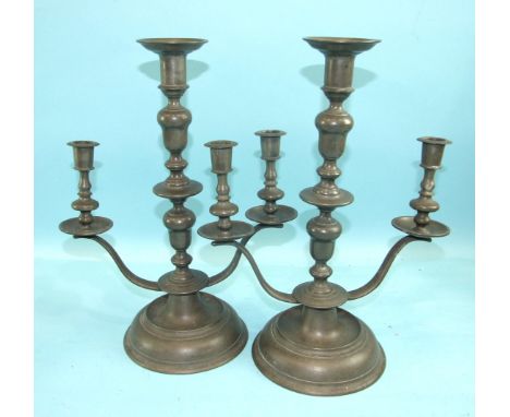 A pair of pewter three-light table candelabra on circular bases, 36cm high, (2).