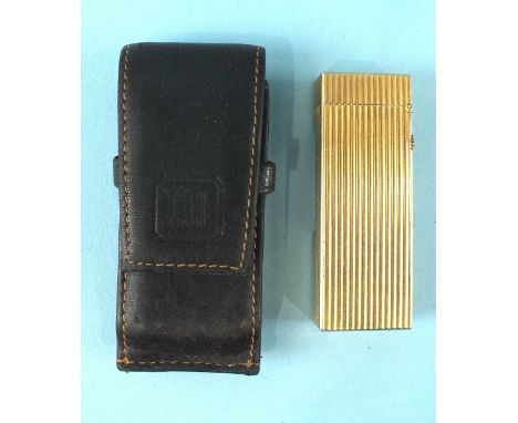 A Dunhill gold-plated lighter, 64mm, with ribbed decoration and leather pouch.