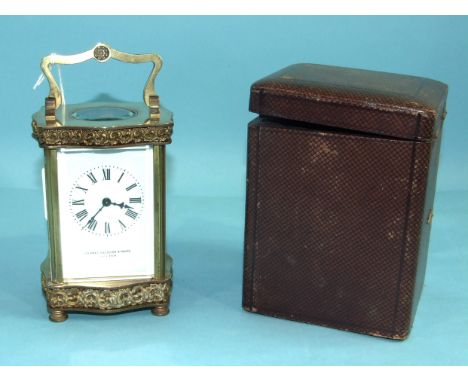 A French brass carriage timepiece, the case of serpentine outline, with decorative frieze and plinth, the white enamel dial m