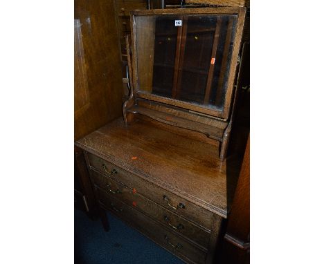 A LIGHT OAK DRESSING CHEST OF THREE DRAWERS, with a single mirror