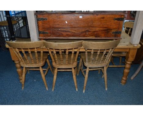 A LARGE PINE TABLE, approximate size width 183cm x depth 92cm x height 74cm, with six light wood spindle back chairs (7)