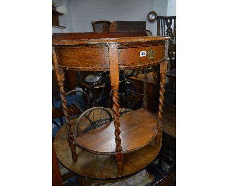 AN OAK BARLEY TWIST DEMI LUNE HALL TABLE, with a single drawer and lower shelf