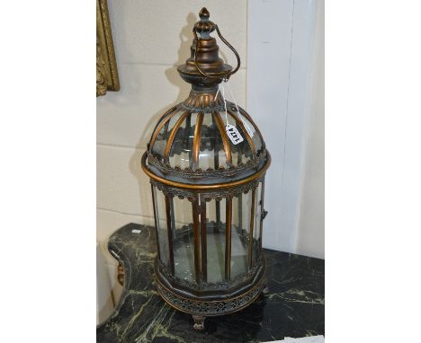 A VICTORIAN STYLE GILT AND HARDWOOD CONSOLE TABLE, carved foliate top rail on four scrolled legs united by a crossed stretche