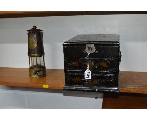 AN ORIENTAL LACQUERED VANITY CASE, with hinged lid revealing mirror above two drawers and a miners lamp, stamped Eccles (2)