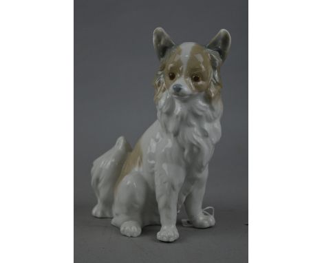 A NAO SEATED DOG, 'Pomeranian', approximate height 21cm