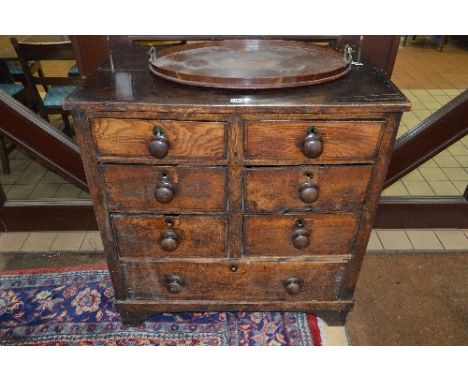 A GEORGIAN AND LATER COUNTRY OAK CHEST, of six short drawers and one long drawer, with turned mahogany handles, panelled side