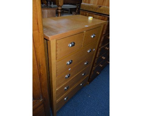 A LIGHT OAK CHEST, of two short and four long drawers, approximate size width 80cm x height 113cm x depth 41cm