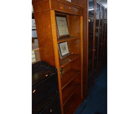 A YEW WOOD MODERN STANDING BOOKCASE, and four pictures including one of a sampler (5)