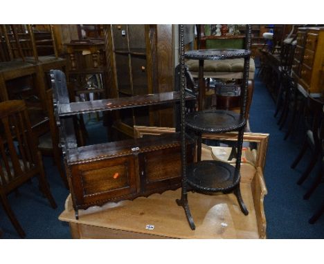 A MAHOGANY TWO DOOR WALL SHELF, a Victorian pot cupboard and an oak folding cake stand (3)