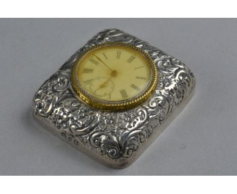 A SILVER AND BRASS TRAVEL CLOCK