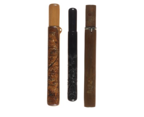 Three kiseruzutsuOne by Shusai, late 19th centuryThe first of brown lacquer, engraved with tama (sacred jewels) and clouds, u