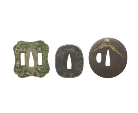 Three tsuba18th/19th centuryThe first of iron, of oval form, inlaid with the peak of Mount Fuji in gold and silver nunome, in