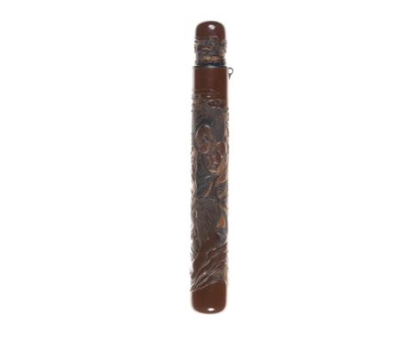 A brown-lacquer kiseruzutsuBy Kinpo, late 19th centuryBoldly carved with a continuous scene of a rakan standing beside a lion