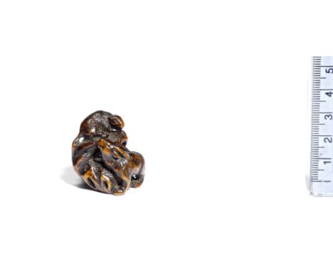 A wood netsuke of two goatsBy Kokei, Tsu, early 19th centuryOne lying on the top of a craggy rock, while the other climbs up 