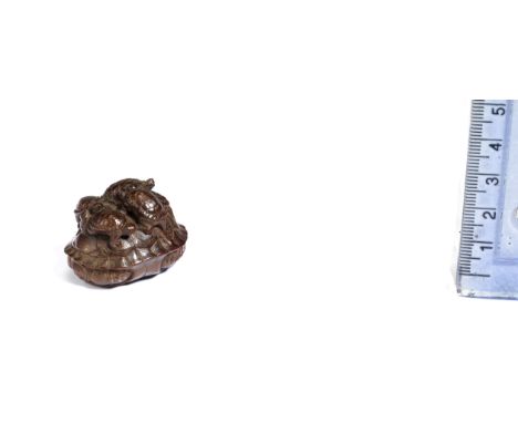 A wood netsuke of tortoisesBy Tomin, Tsu, early 19th centuryOne large tortoise forming a base for its six young to clamber up
