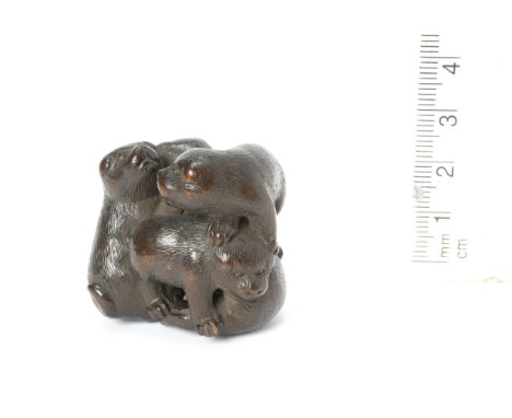 A wood netsuke of five puppiesBy Yukisada, 19th centuryFour tumbling over each other as they play, while the fifth sits at th