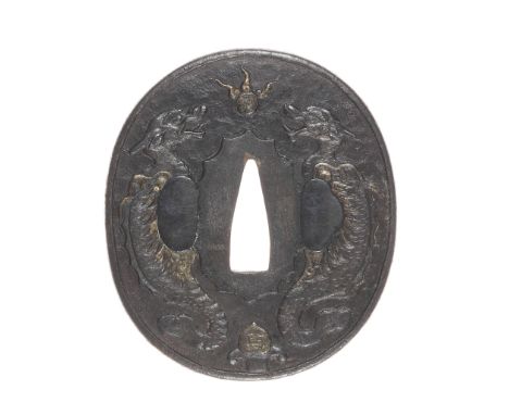 An iron tsubaNanban school, 18th centuryOf oval form, carved in low relief with two dragons disputing a flaming pearl, the re