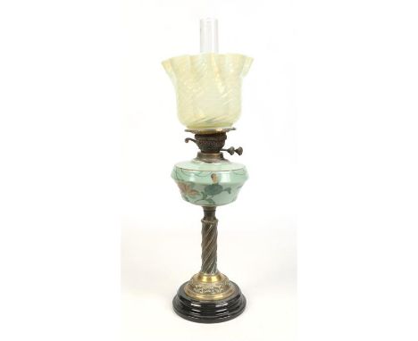 A Victorian brass based oil lamp with opaque glass font enamelled with flowers and having a Vaseline glass shade, 66.5cm tota