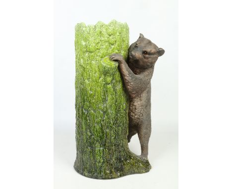 A Bretby stick stand in the Black Forest style. Modelled as a brown bear with glass inset eyes leaning against a tree trunk, 