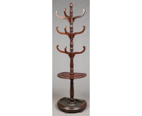 A Regency mahogany bow fronted hat and coat stand. With turned centre column and scrolling pegs, 2m 10cm.Condition report int