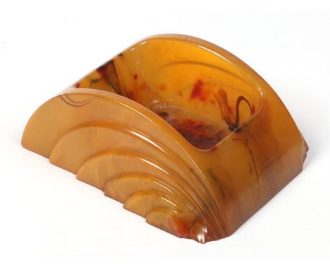 An Art Deco Butterscotch amber coloured bakelite inkwell. Stamped A Dickinson Product, 10cm.Condition report intended as a gu