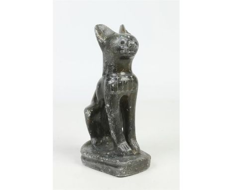 An Egyptian carved jade coloured soapstone sculpture of the feline goddess Bastet in sejant attitude raised on a rounded plin