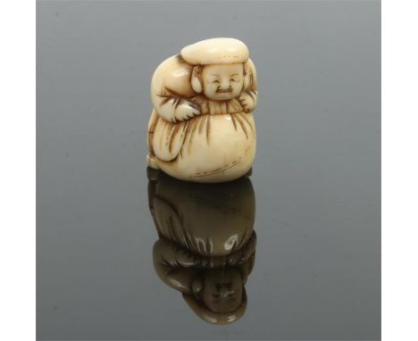 A Japanese Meiji period carved ivory netsuke. Formed as a man leaning upon a large sack, 3.75cm.Condition report intended as 