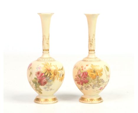 A pair of Royal Worcester bottle vases. Blush ground and painted with bouquets of wild flowers. Printed green marks, date cod