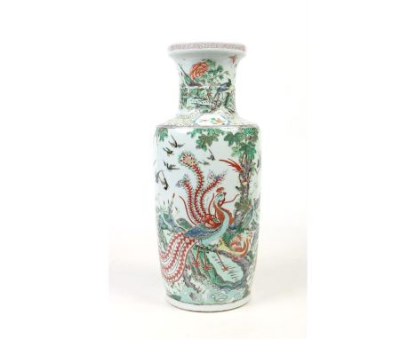 A large 19th century Chinese famille vert rouleau vase. Painted in coloured enamels with peacocks and other birds in a contin