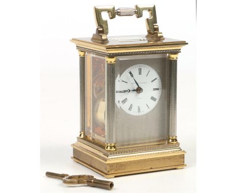 A brass cased carriage clock by Matthew Norman, London. With silvered fluted column supports and engine turned engraved dial 