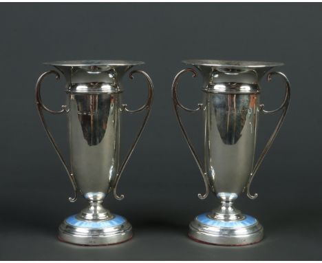 A pair of George V silver mantel vases by Patterson &amp; Sons Ltd. Each with twin scrolling handles and raised on stepped ci