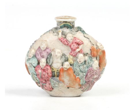 A 19th century Chinese snuff bottle. Moulded in relief with a procession of figures on a textured ground. Painted qianglong s