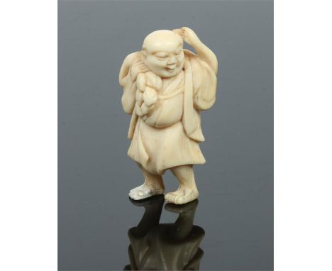 A Japanese Meiji period ivory netsuke. Formed as a man stood holding a sack over one shoulder. Signed to the reverse, 5cm.Con