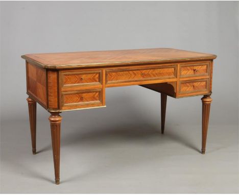 A French early 20th century kingwood kneehole desk. Quarter veneered, with gilt metal mounts and raised on reeded tapering su