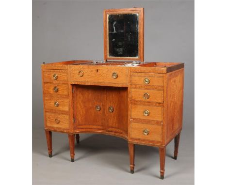 A ladies Regency satinwood metamorphic kneehole vanity table in the manner of Mayhew &amp; Ince. With stepped top hinging to 