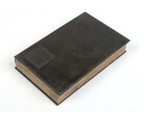 An early 20th century Chinese book with carved hardwood cover, possibly zitan. Decorated front and back with dragons chasing 