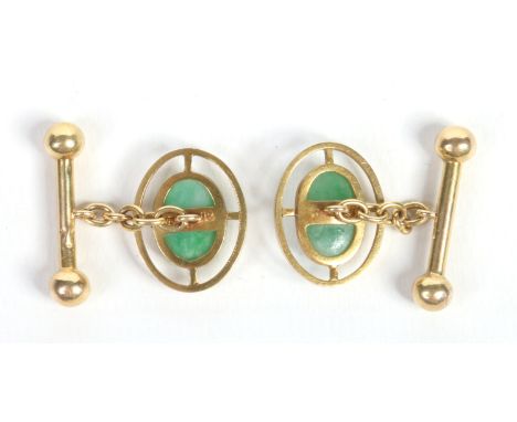 A cased pair of Chinese 18 carat gold cufflinks each set with an ovoid jadeite tablet. Case marked for Wo Shing, Shanghai. 1.