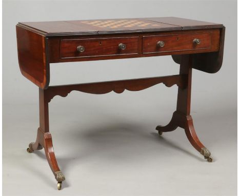 A Regency mahogany sofa table. With a reversible parquetry gaming board top, crossbanded, with reeded mouldings and raised on