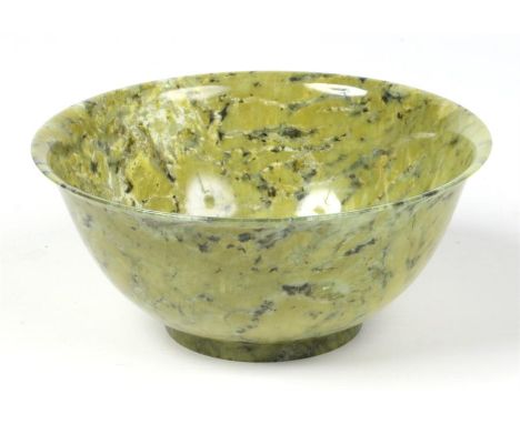 A 20th century Chinese mottled jade bowl of plain turned form and with everted rim, 12.5cm diameter.Condition report intended