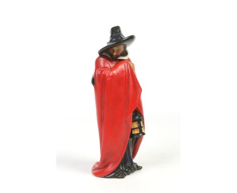 A rare Royal Doulton figure by Charles J. Noke. 'Guy Fawkes' modelled wearing a long red cloak and holding a lantern. Impress