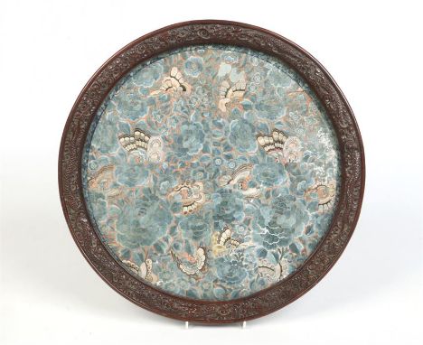 An early 20th century Chinese circular silk embroidered panel depicting butterflies and flowers predominantly in blue and hou