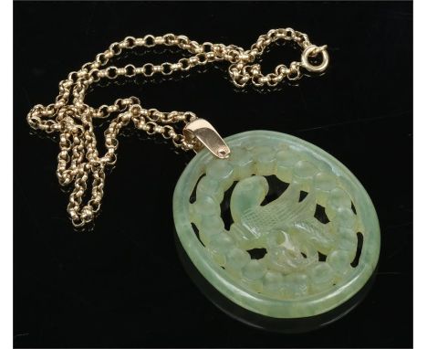 A Chinese jade pendant of oval form. Pierced and carved to depict a parrot. Supported on a 9 carat gold chain. Pendant 5.25cm