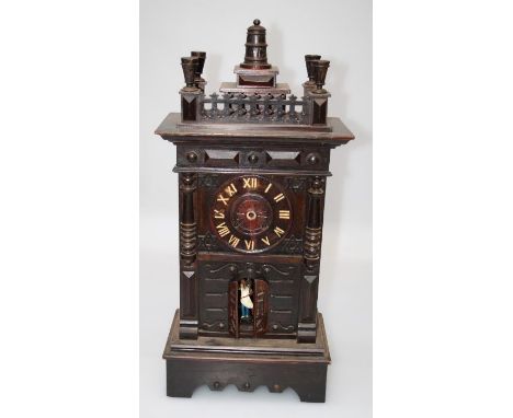 An early 20th century Black Forest mantle clock of large proportions, the architectural case with hinged door revealing Moori