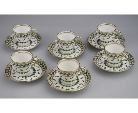 A set of six Mintons coffee cans and saucers, retailed by Goode, each with enamel relief decorated with rosebuds and leaves o