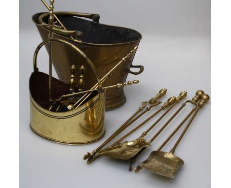 A 19th century brass helmet shape coal scuttle with swing handle, another later scuttle, a three piece companion stand, pair 