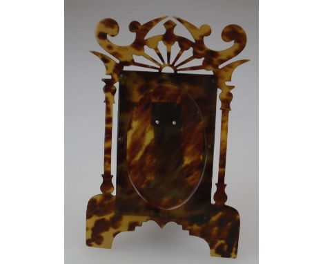 A tortoiseshell easel photograph frame having a pierced surmount. H19cm
