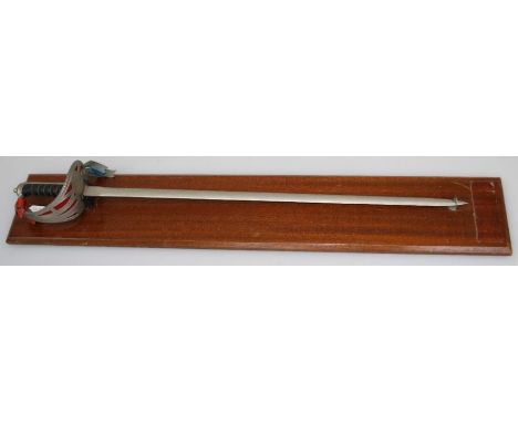 A QE II presentation Wilkinson sword, with wirebound grip, pierced guard and 76cm florally chased blade. Mounted on wood plin