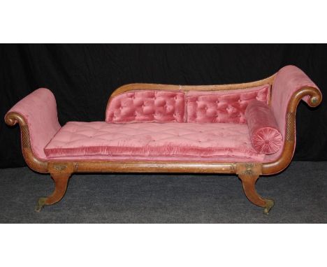 A Regency gilt metal mounted double scroll ended chaise longue, with bergere cane back, pale raspberry velour upholstery and 
