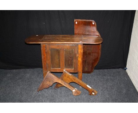 A small early 20th century Continental provincial oak and elm drop flap single door cupboard, on shaped supports, 71 x 100 x 