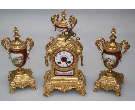 A 20th century French gilt metal and painted enamel mantle clock, the case with urn finial over Arabic dial enclosing an eigh